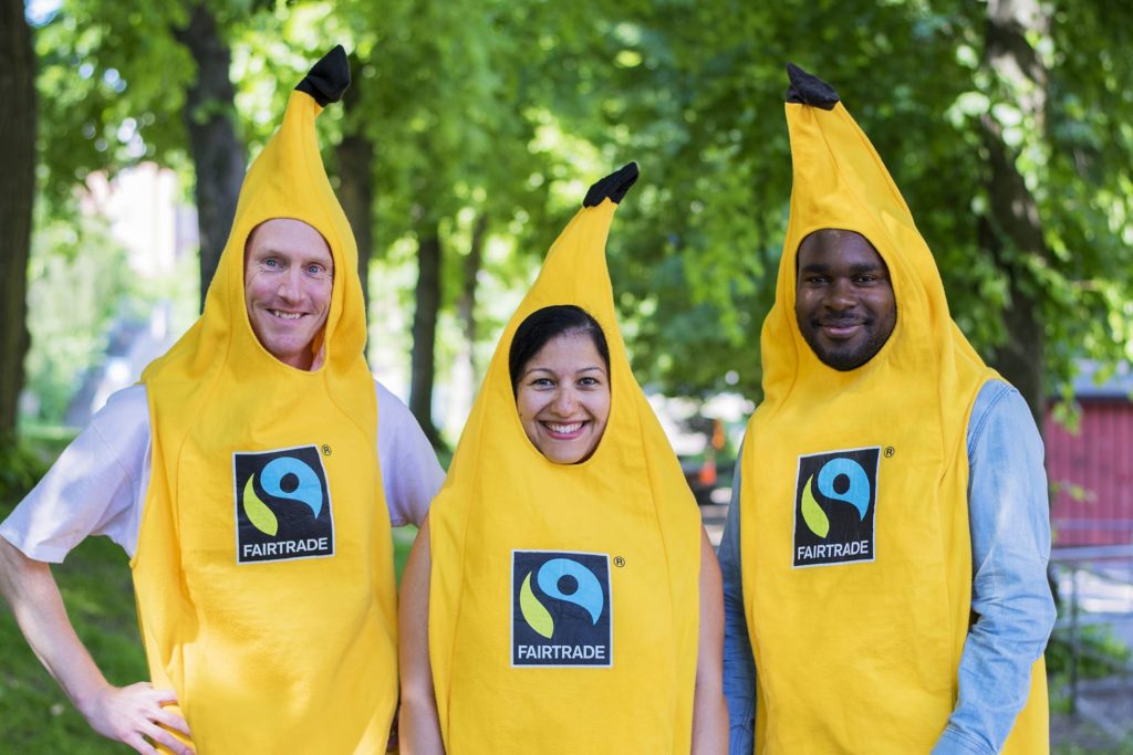 Three people in banana costumes, outdoor image