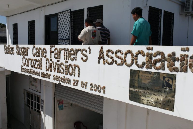 The facade of the Belize Sugar Cane Farmers Association (BSCFA) office in Corozal displays a plaque that reads: "Building Inauguration Funded with Fairtrade Funds on February 14th, 2011."