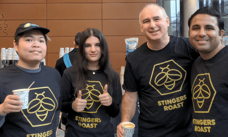 Oliver De Volpi with three of Concordia's Fairtrade ambassadors, all wearing Stingers Roast shirts.